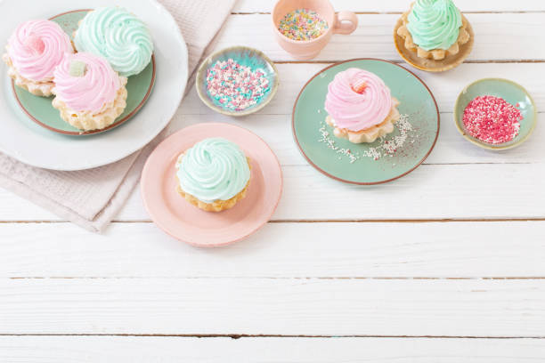 istock cupcakes on plates on white wooden background 1397940653