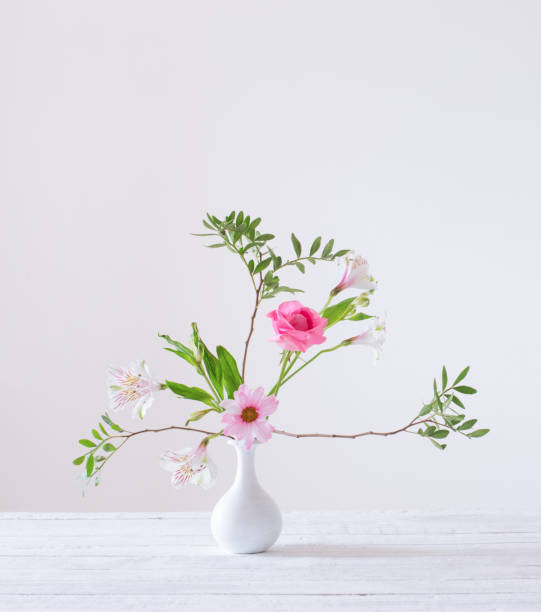 istock pink and white flowers in vase on white background 1397940665