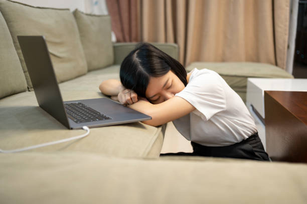 istock Asian woman getting tired while working late at home with laptop at night 1397940845