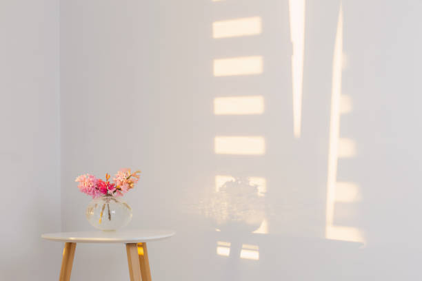 istock spring flowers in glass vase on background white wall in sunlight 1397941690