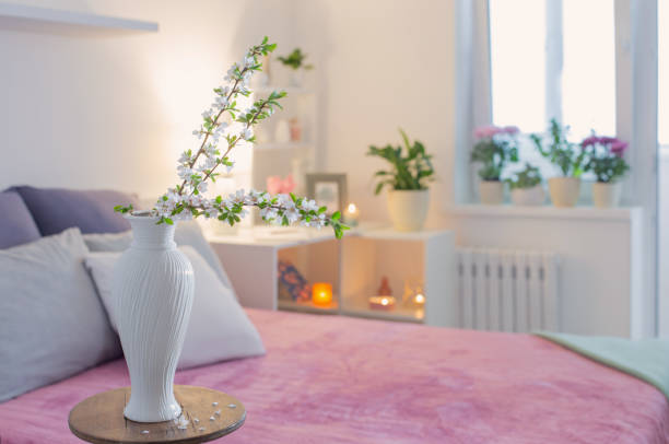 istock pink and white interior of bedroom with spring flowers 1397941699