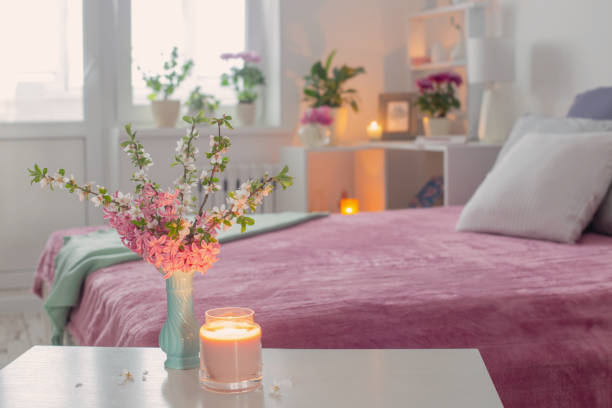 istock pink and white interior of bedroom with spring flowers 1397941701