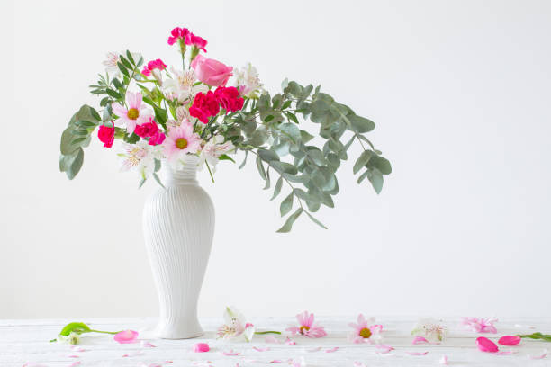 istock pink and white flowers in vase on white background 1397941752