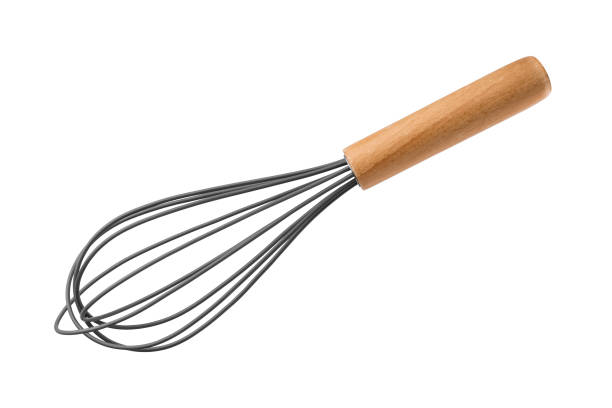 Kitchen whisk with wooden handle on a white background. Kitchen tool concept