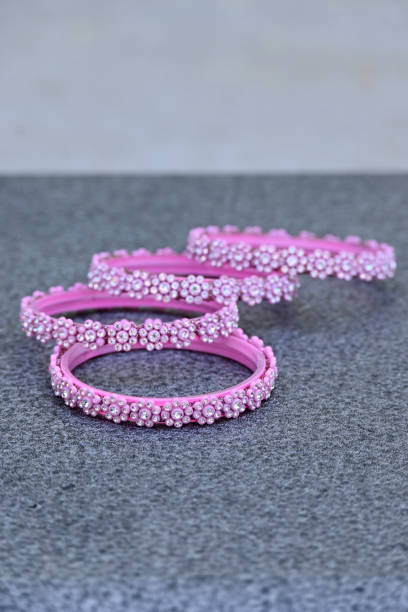 istock closeup the bunch pink silver bangle over out of focus grey background. 1397943918