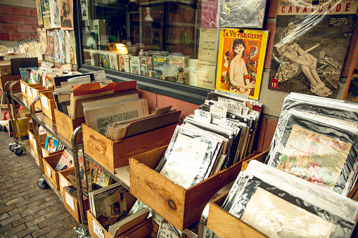 May 2, 2022: Flea Market “Marché Dauphine” in Paris. The Marché Dauphine is the largest covered market of the Saint-Ouen flea market. Under a glass roof of 3000 m², it brings together 150 dealers of all specialties. It is, in fact, the most eclectic market of the Flea market: classical antiquities, 20th century furniture, collection watches, jewelery, galleries and contemporary art galleries, on the ground floor; While the first floor gathers music collectors, booksellers, vintage fashion and more.