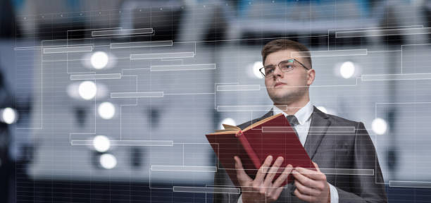 businessman with a reference book in his hands looking at the production plan . - financial occupation research data glasses imagens e fotografias de stock