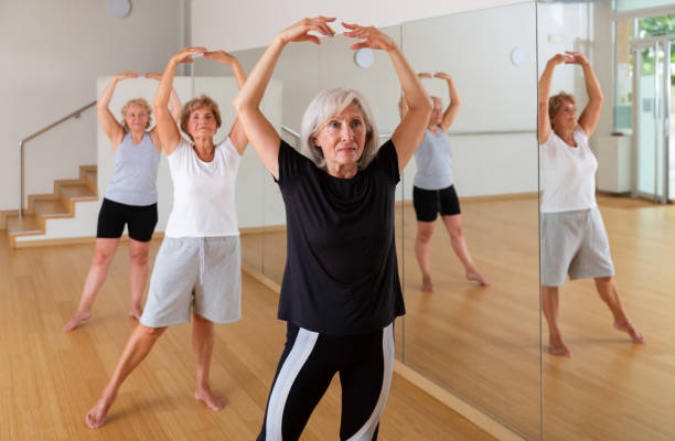 istock Mature active women perform ballet exercises in the studio 1397949272
