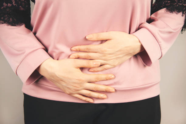 istock woman hand in ache stomache 1397950185