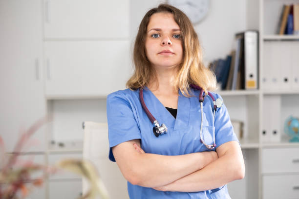 istock Woman doctor standing inside office, looking at camera 1397951721