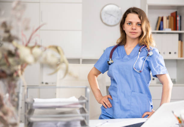 istock Woman doctor standing inside office, looking at camera 1397951727