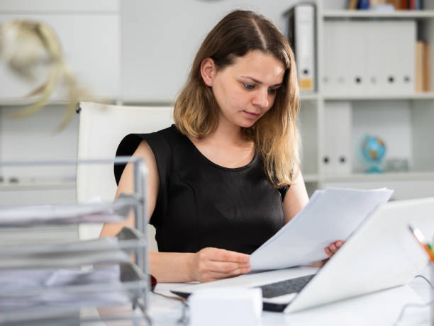 istock Business woman working with documents and laptop in office 1397951756