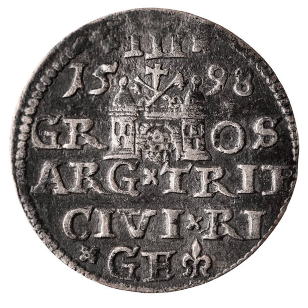 istock Single old silver coin 16th century isolated on white background. Reverse of three groschen with Greater coat of arms of Riga. Closeup. 1397953115