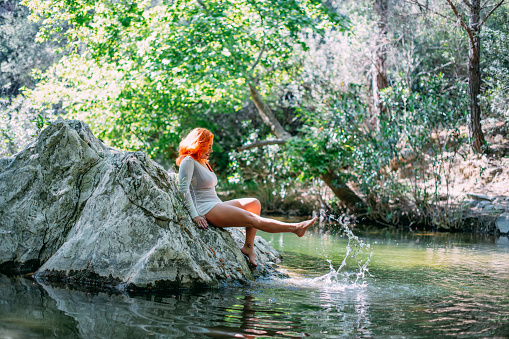 Attractive Redhead Woman in the Untouched River