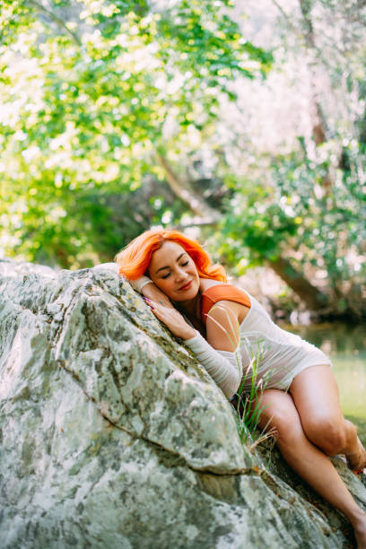 Beautiful Redhead Woman in the Untouched Forest and River