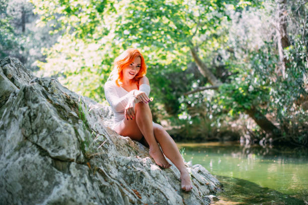 Beautiful Redhead Woman in the Untouched Forest and River