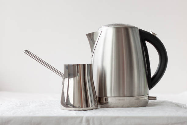 istock On a white background there is an iron electric kettle and an iron turk. Coffee making concept, good morning, breakfast, dishes 1397953786