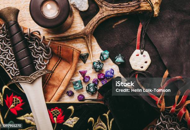 Fantasy Role Playboard Game Still Life Concept Background Decoratedcharacter Objects Tools Dagger Dragons Dungeonschain Mail Amulet Clothing Dice Setd10 D20 D12 D6 D8 Stock Photo - Download Image Now
