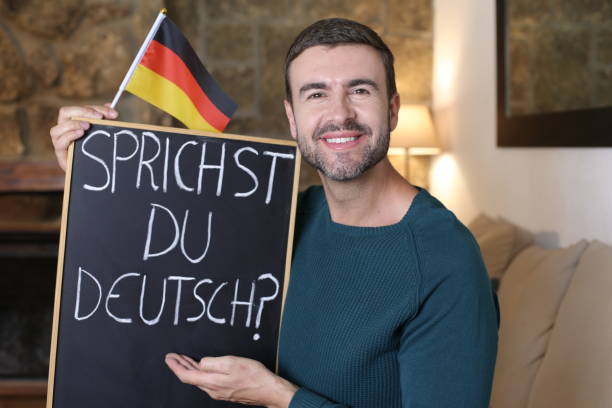 German teacher holding blackboard and flag stock photo