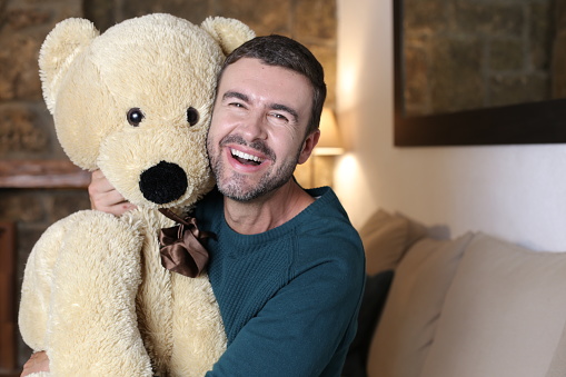 Adult man showing love for teddy bears.