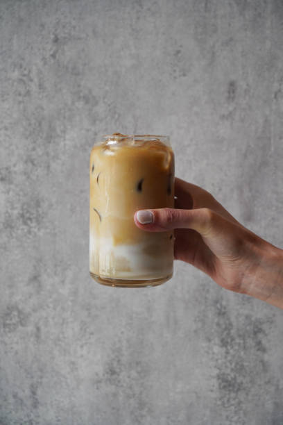 istock Hand with Ice coffee glass, close-up 1397957741