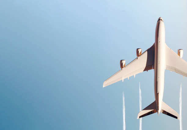 Top view of commercial airplane flying above the clouds Top view of commercial airplane flying above the clouds 3D Rendering, 3D Illustration planes flying overhead stock pictures, royalty-free photos & images