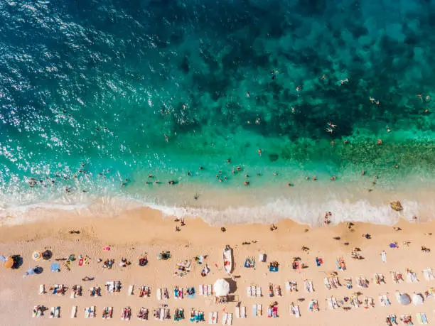 Drone footage of people sunbathing on Kaputaş beach near Kalkan - Kaş, Antalya, Turkey