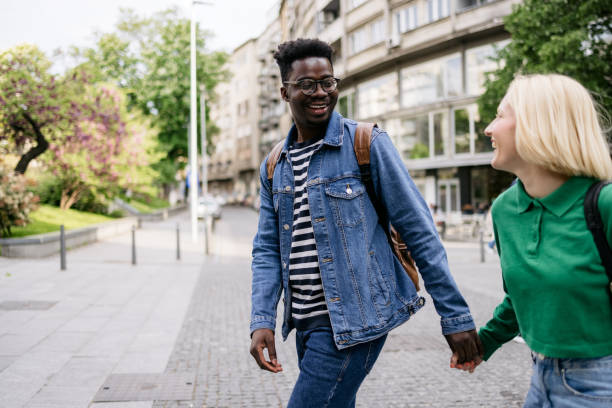 istock Happy diverse couple walking around the city 1397960686