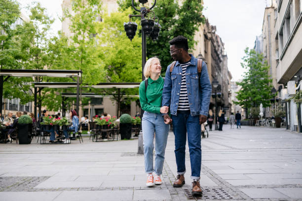 istock Happy diverse couple walking around the city 1397960732