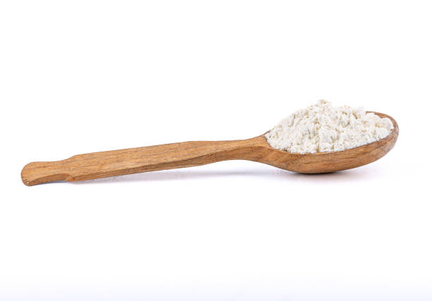 istock Wooden spoon with wheat flour on a white background. 1397961870
