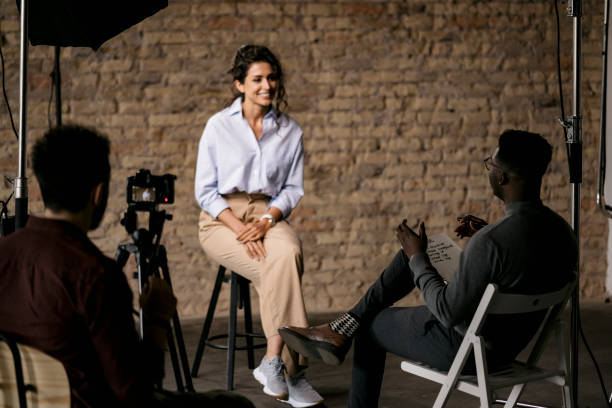 istock Journalist interviewing a young woman in a studio 1397962039