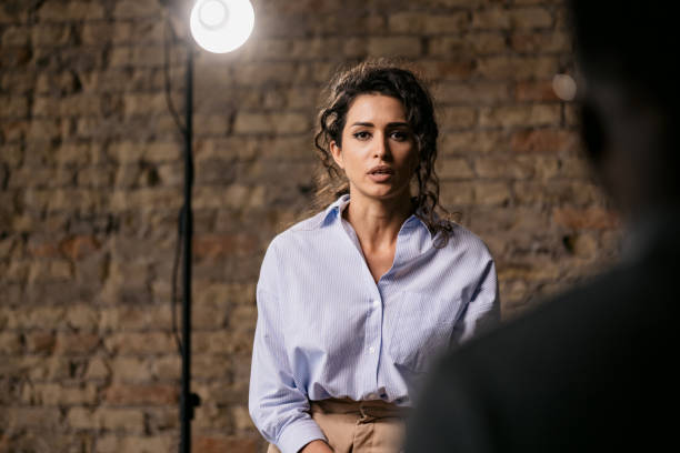 istock Attractive woman giving an interview in a modest studio 1397962102