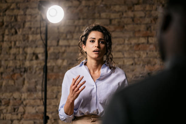 istock Attractive woman giving an interview in a modest studio 1397962104