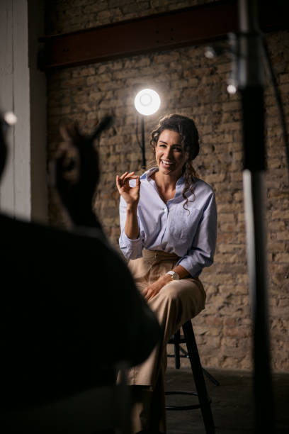 Young woman giving an interview in a studio