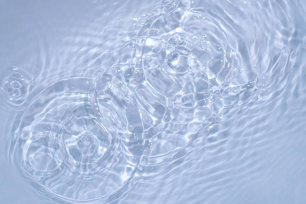 istock Circles on water. Blue round shadows. Blurred background made with water and light in monochrome. 1397964237