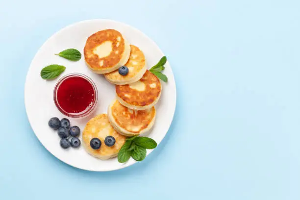 Cottage pancakes with berry jam and berries. Top view flat lay with copy space