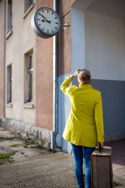 young girl walking along railway station,