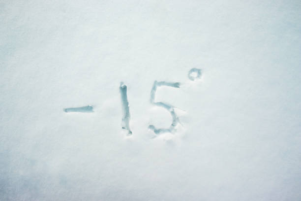 handwritten temperature on the snow surface. 15 degrees below zero. cold and frosty weather concept - letter c imagens e fotografias de stock