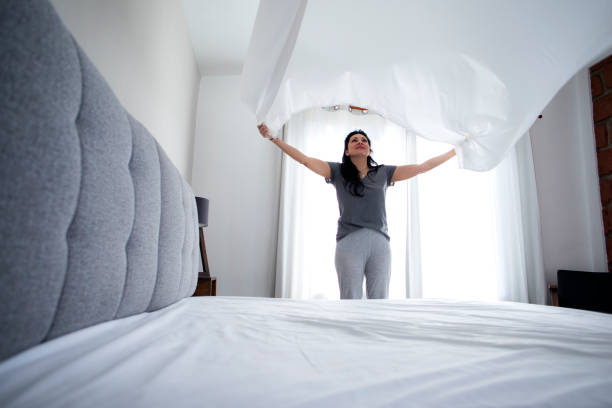 istock woman making the bed 1397965609