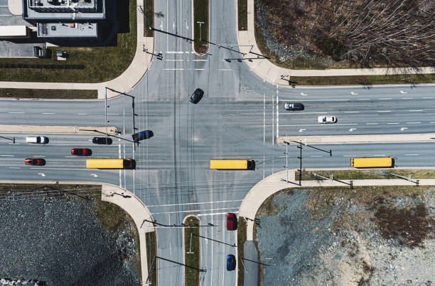 A trio of school buses drive through an intersection.