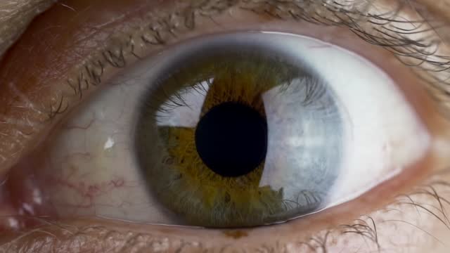 Close-up of Human Eye and Flying in Space with Stars and Planets