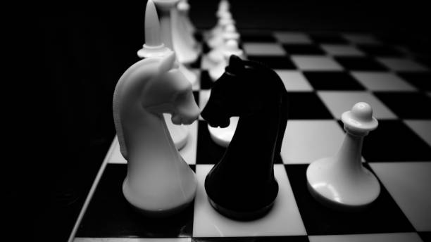 istock White and black chess pieces on a chessboard black and white photography 1397968620