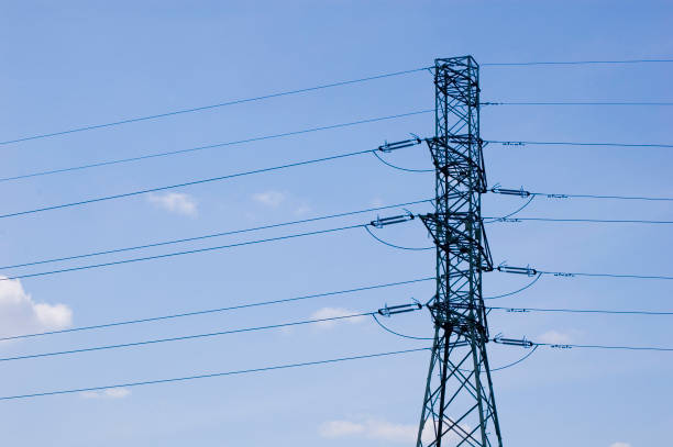 istock High voltage transmission tower over blue sky. 1397969229