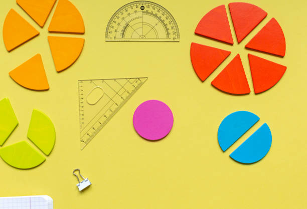 istock Multicolored fractions, rulers, pencils on yellow background. Interesting, fun math for kids. Education, back to school concept 1397970664