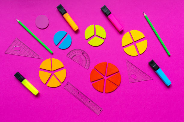 istock Multicolored fractions, rulers, pencils on a magenta pink background. Interesting, fun math for kids. Education, back to school concept 1397970722