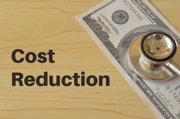 Stethoscope and money banknote with text COST REDUCTION.