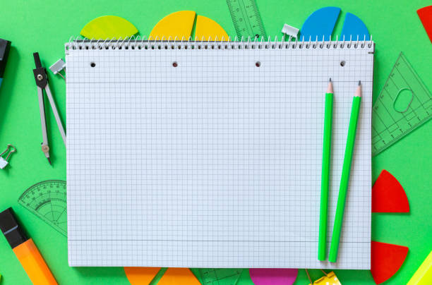 istock School supplies, open notepad, rulers, fractions on a green background. Interesting, fun math for kids. Education, back to school concept 1397970944