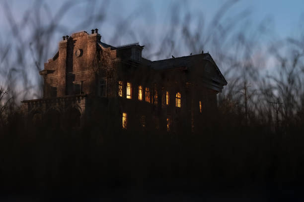 istock Eerie dilapidated historic manor with illuminated windows at dawn. 3D render. 1397971910