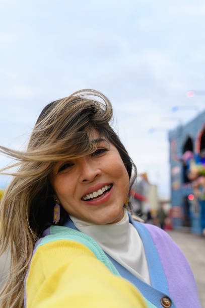 istock Smiling young woman looking at camera in amusement park 1397973343