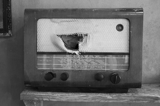 Front view of a vintage retro radio with broken speaker